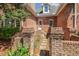 Brick home featuring a welcoming front entrance with stone pathway, brick columns, and a white door at 129 Trellingwood Dr, Morrisville, NC 27560