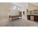 Entertain in this game room featuring a billiards table, skylights and a bar area at 129 Trellingwood Dr, Morrisville, NC 27560