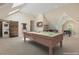 Spacious game room boasts a billiard table, bar, dart board, and laundry for convenience at 129 Trellingwood Dr, Morrisville, NC 27560