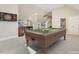 Spacious game room features a billiard table, dart board and bar area for entertaining at 129 Trellingwood Dr, Morrisville, NC 27560