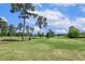 Expansive golf course with pristine fairways, mature trees, and players enjoying a sunny day on the green at 129 Trellingwood Dr, Morrisville, NC 27560
