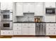 Kitchen features stainless steel appliances, backsplash, and white cabinetry at 129 Trellingwood Dr, Morrisville, NC 27560