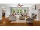 Open-concept living room featuring hardwood floors, fireplace, and glass doors to the backyard at 129 Trellingwood Dr, Morrisville, NC 27560