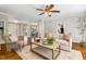 Spacious living room with hardwood floors, neutral decor, and comfortable seating is ideal for relaxation at 129 Trellingwood Dr, Morrisville, NC 27560