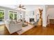 Bright living room boasts hardwood floors, fireplace, and glass doors to the backyard at 129 Trellingwood Dr, Morrisville, NC 27560