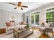 Comfortable living room with hardwood floors, neutral decor, and views to the backyard through the french doors at 129 Trellingwood Dr, Morrisville, NC 27560