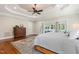 Bright main bedroom with tray ceilings, ceiling fan, and doors to a sunroom at 129 Trellingwood Dr, Morrisville, NC 27560