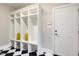Spacious mud room features custom built-in lockers and black-and-white checkerboard tile at 129 Trellingwood Dr, Morrisville, NC 27560