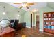 Spacious office with hardwood floors, natural light, a bookcase, and office furniture for functionality and productivity at 129 Trellingwood Dr, Morrisville, NC 27560