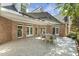 Relax on this covered brick patio, perfect for outdoor dining and entertaining at 129 Trellingwood Dr, Morrisville, NC 27560