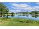 Scenic pond with reflection of beautiful homes and trees and the blue sky with fluffy clouds at 129 Trellingwood Dr, Morrisville, NC 27560