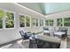 Bright and airy sunroom with lots of windows, seating, and a vaulted ceiling. Overlooks the backyard at 129 Trellingwood Dr, Morrisville, NC 27560