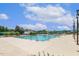 Outdoor pool area with diving blocks, umbrellas, and chairs with a slide visible in the background at 129 Trellingwood Dr, Morrisville, NC 27560