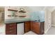 Modern wet bar featuring sleek cabinetry, mini-fridge, and stylish backsplash at 129 Trellingwood Dr, Morrisville, NC 27560