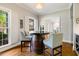 Cozy wine room with charming barrel table and chairs, illuminated by natural light from adjacent windows at 129 Trellingwood Dr, Morrisville, NC 27560