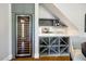 The wine room features a built-in wine cooler and custom shelving for storing both bottles and glassware at 129 Trellingwood Dr, Morrisville, NC 27560