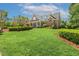 Beautifully landscaped front yard of a brick home, showcasing a well-maintained lawn and shrubbery at 129 Trellingwood Dr, Morrisville, NC 27560