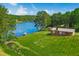 Breathtaking aerial view showcases a home on expansive lawn, adjacent to a serene lake at 1415 Clearwater Dr, Sanford, NC 27330