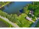 Scenic aerial view of lakefront homes with lush greenery and crystal-clear water at 1415 Clearwater Dr, Sanford, NC 27330