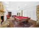Finished basement area featuring a pool table, stone fireplace, and walkout to the yard at 1415 Clearwater Dr, Sanford, NC 27330