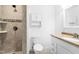 Well-lit bathroom showcasing tiled walk-in shower, vanity with a granite counter, and storage at 1415 Clearwater Dr, Sanford, NC 27330