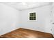 Bright bedroom with wood floors, a large window, and fresh neutral paint at 1415 Clearwater Dr, Sanford, NC 27330