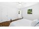 Sunny bedroom with a wrought iron bed, wood floors, and an adjacent open doorway at 1415 Clearwater Dr, Sanford, NC 27330
