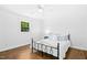 Relaxing bedroom with white walls, wood floors, and a cozy wrought iron bed frame at 1415 Clearwater Dr, Sanford, NC 27330