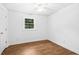 Comfortable bedroom with hardwood floors, window, and ample natural light at 1415 Clearwater Dr, Sanford, NC 27330