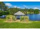 Picturesque gazebo on a lake, surrounded by lush greenery and a serene blue sky at 1415 Clearwater Dr, Sanford, NC 27330