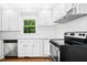 Close-up of the updated kitchen with white cabinets, stainless steel appliances, and granite countertops at 1415 Clearwater Dr, Sanford, NC 27330
