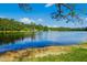 Scenic lake view showcasing clear water reflecting a bright blue sky and lush greenery at 1415 Clearwater Dr, Sanford, NC 27330