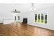 Bright, open living space with a modern ceiling fan, cozy fireplace, and large windows offering a view of the outdoors at 1415 Clearwater Dr, Sanford, NC 27330