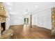 Open living room boasts wood floors, stone fireplace, and a textured ceiling with recessed lights at 1415 Clearwater Dr, Sanford, NC 27330