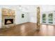 Inviting living room features a stone fireplace, wood floors, and French doors to the outside at 1415 Clearwater Dr, Sanford, NC 27330