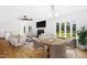 Open-concept living and dining area with modern furnishings, a cozy fireplace, and large windows providing plenty of natural light at 1415 Clearwater Dr, Sanford, NC 27330