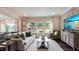 Inviting living room with stylish furnishings, large windows overlooking the backyard, and modern decor at 1428 Goldfinch Perch Ln, Knightdale, NC 27545