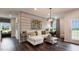 Inviting living space featuring a white sofa, stylish decor, and a cozy workspace by the window at 1428 Goldfinch Perch Ln, Knightdale, NC 27545