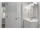 Bathroom featuring a single sink vanity, decorative light fixture and an adjacent linen closet at 1442 Aversboro Rd # 7, Garner, NC 27529