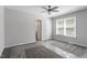 A bright bedroom offers neutral paint, a ceiling fan, and a large window at 1442 Aversboro Rd # 7, Garner, NC 27529