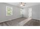 Bedroom with neutral gray walls, carpet, ceiling fan, and natural light from two windows at 1442 Aversboro Rd # 7, Garner, NC 27529