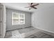 A bright bedroom offers neutral paint, a ceiling fan, and a large window at 1442 Aversboro Rd # 7, Garner, NC 27529