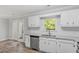 Bright kitchen features white cabinets, stainless appliances, granite countertops, and wood-look flooring at 1442 Aversboro Rd # 7, Garner, NC 27529