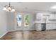 Bright kitchen features white cabinets, stainless appliances, and wood-look flooring, plus sliding doors to the patio at 1442 Aversboro Rd # 7, Garner, NC 27529