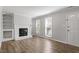 Bright living room featuring hardwood flooring, fireplace and large windows at 1442 Aversboro Rd # 7, Garner, NC 27529