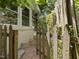 Backyard of home featuring partial view of brick exterior with a wooden fence at 1521 N Duke St, Durham, NC 27701