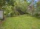 Backyard of home featuring a grassy lawn with mature trees and foliage at 1521 N Duke St, Durham, NC 27701
