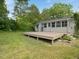 Lush backyard with a wooden deck and a screened-in sunroom at 1521 N Duke St, Durham, NC 27701