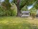 Backyard of home featuring a grassy lawn, mature tree and a home with a deck at 1521 N Duke St, Durham, NC 27701