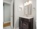 Bathroom with vanity, stylish light fixture and mirror and wood look flooring at 1521 N Duke St, Durham, NC 27701